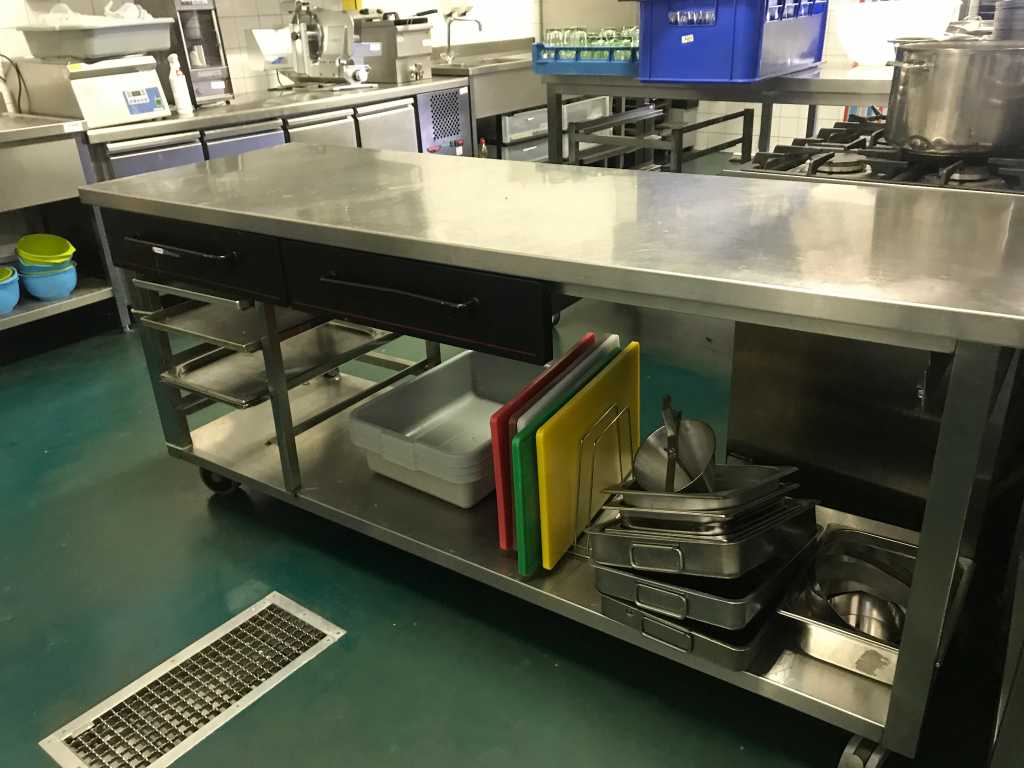 Stainless steel mobile work table with various kitchen accessories