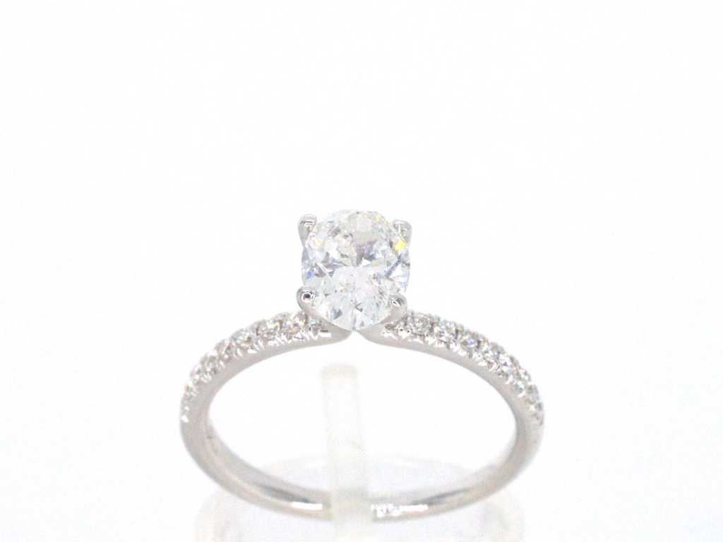 White gold solitaire ring with 1.00 carat oval cut diamond and Brilliant cut diamonds